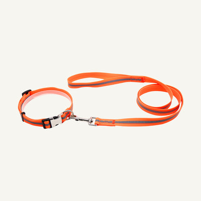 Custom reflective PVC textured dog collar leash set shown in orange with reflective center stripe and buckle
