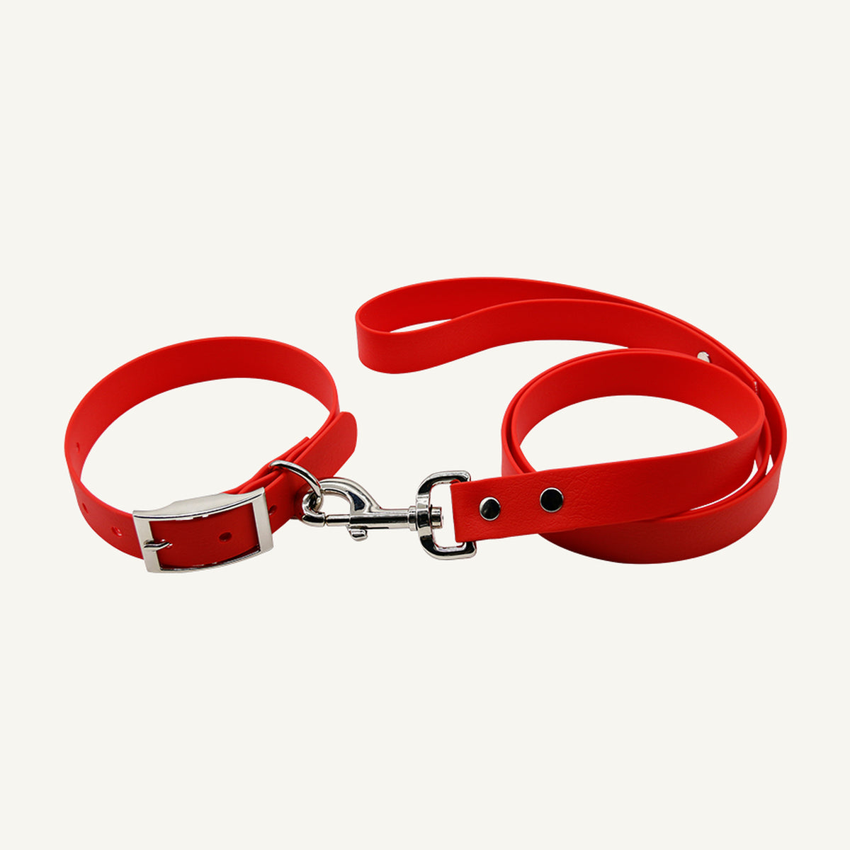 Custom solid PVC integrated dog collar leash set shown in red with silver tone metal hardware