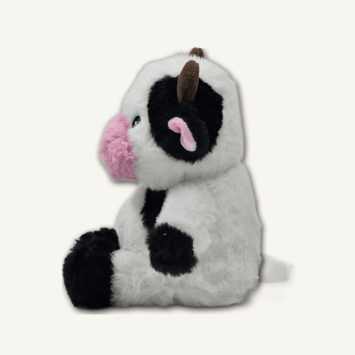 Seated Cow Plush Toy – GMR464 side perspective view on warm neutral background for wholesale pet brands