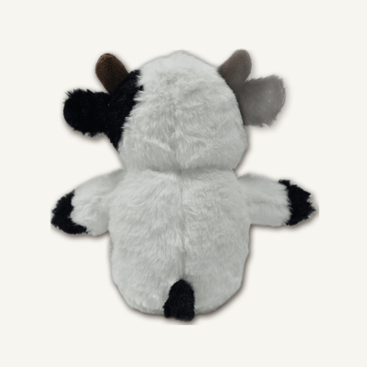 Seated Cow Plush Toy – GMR464 rear perspective view on warm neutral background for wholesale pet brands