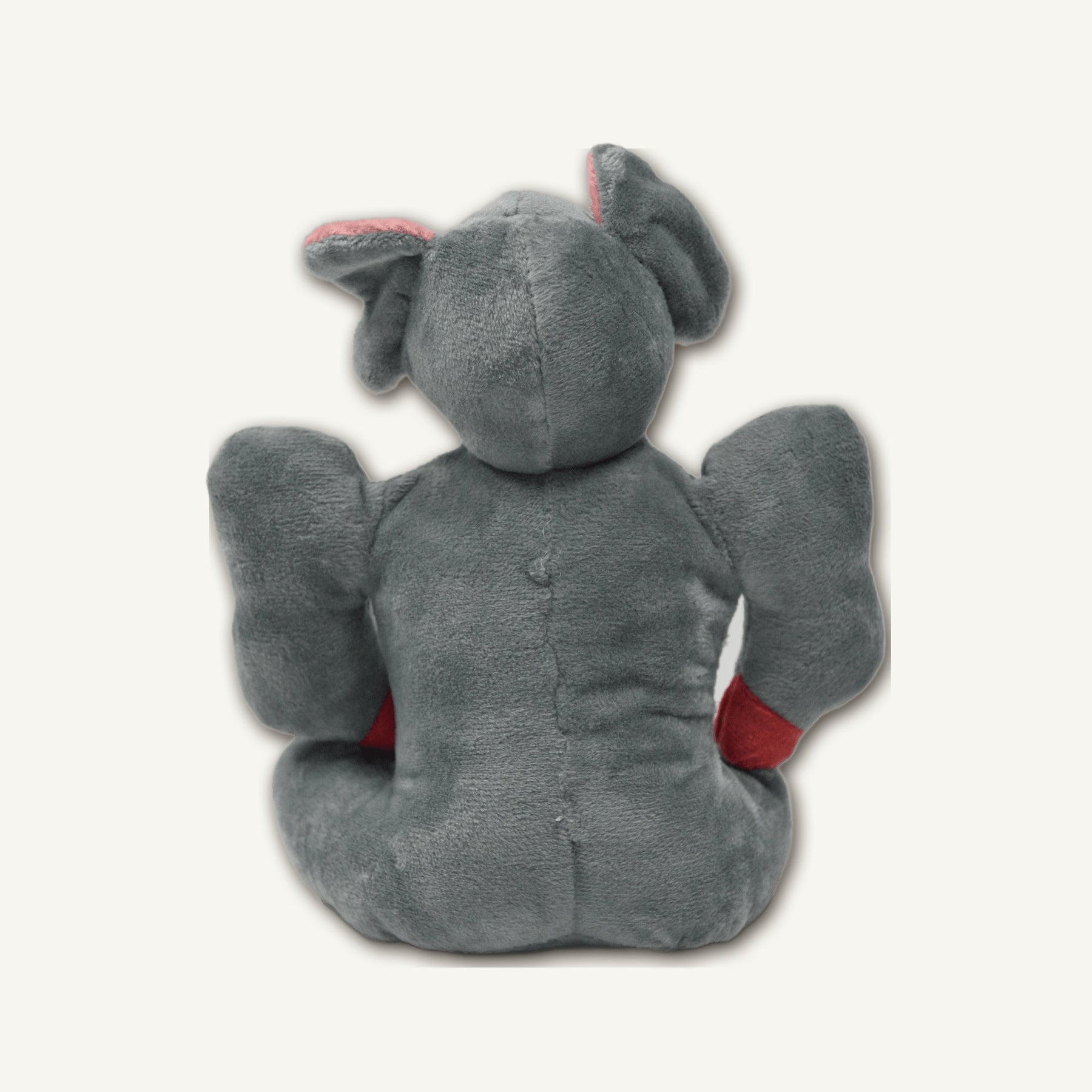 Small Muscle Elephant Rubber Plush Toy – GMX103 rear perspective view on warm neutral background for wholesale pet brands